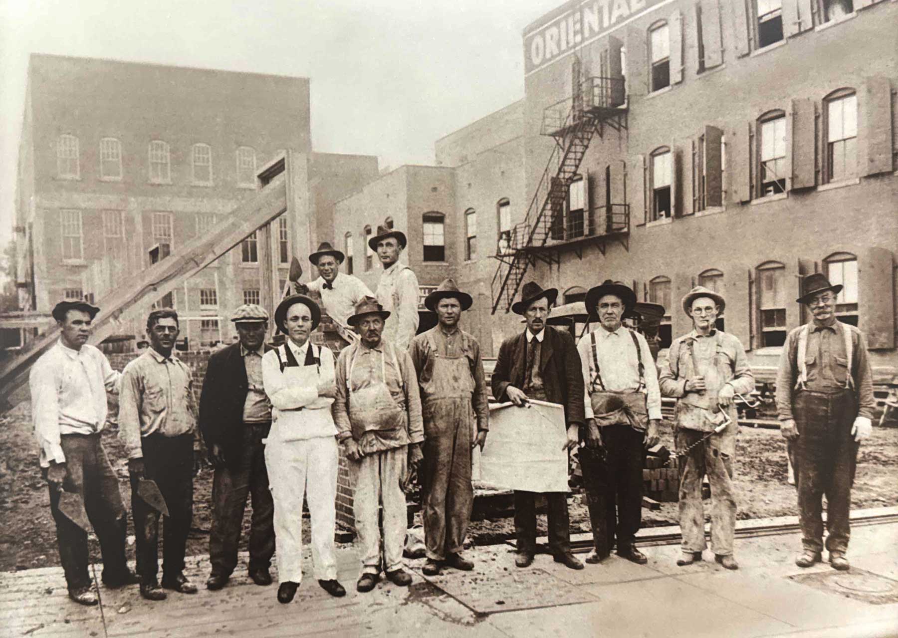 A.C. Schwarz and team (A.C. is holding plans)